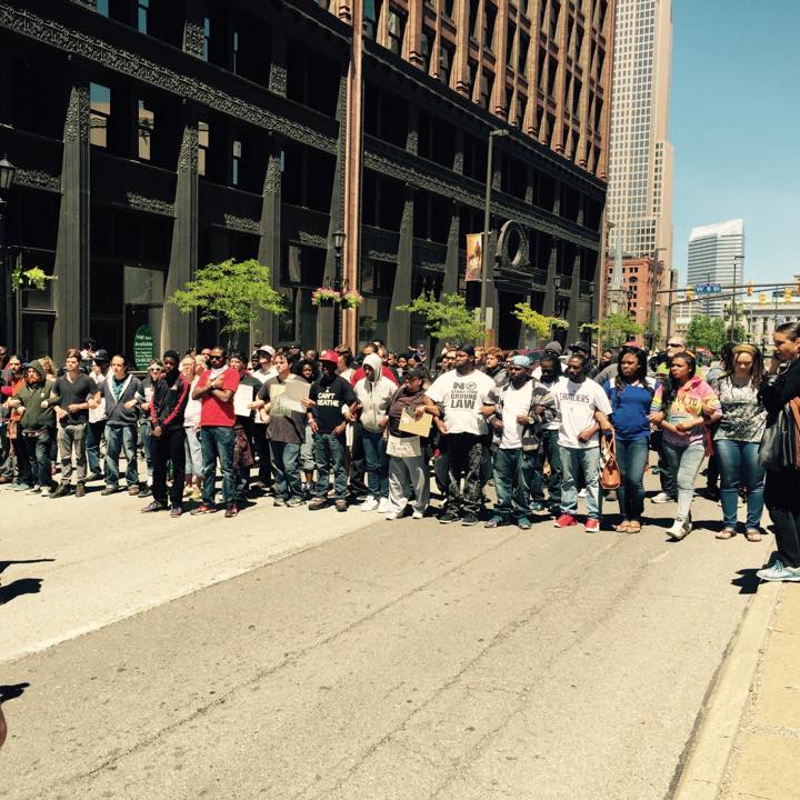 A BMLP Legal Observer observing protestors locking arms and blocking a street in Cleveland